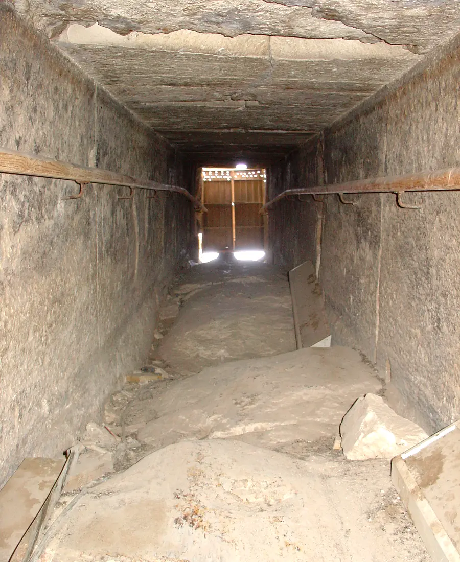 Damaged corner exposing core masonry beneath limestone casing