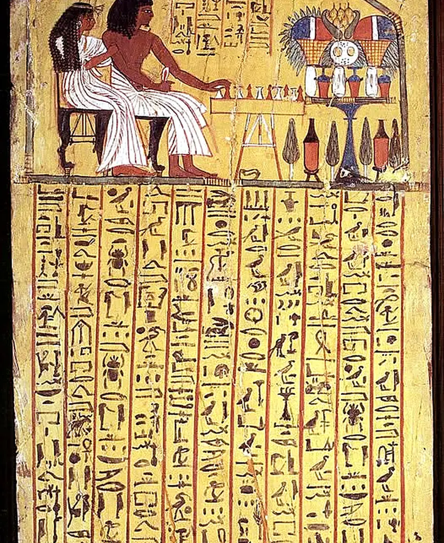 Painted funerary stela showing a seated couple and offerings