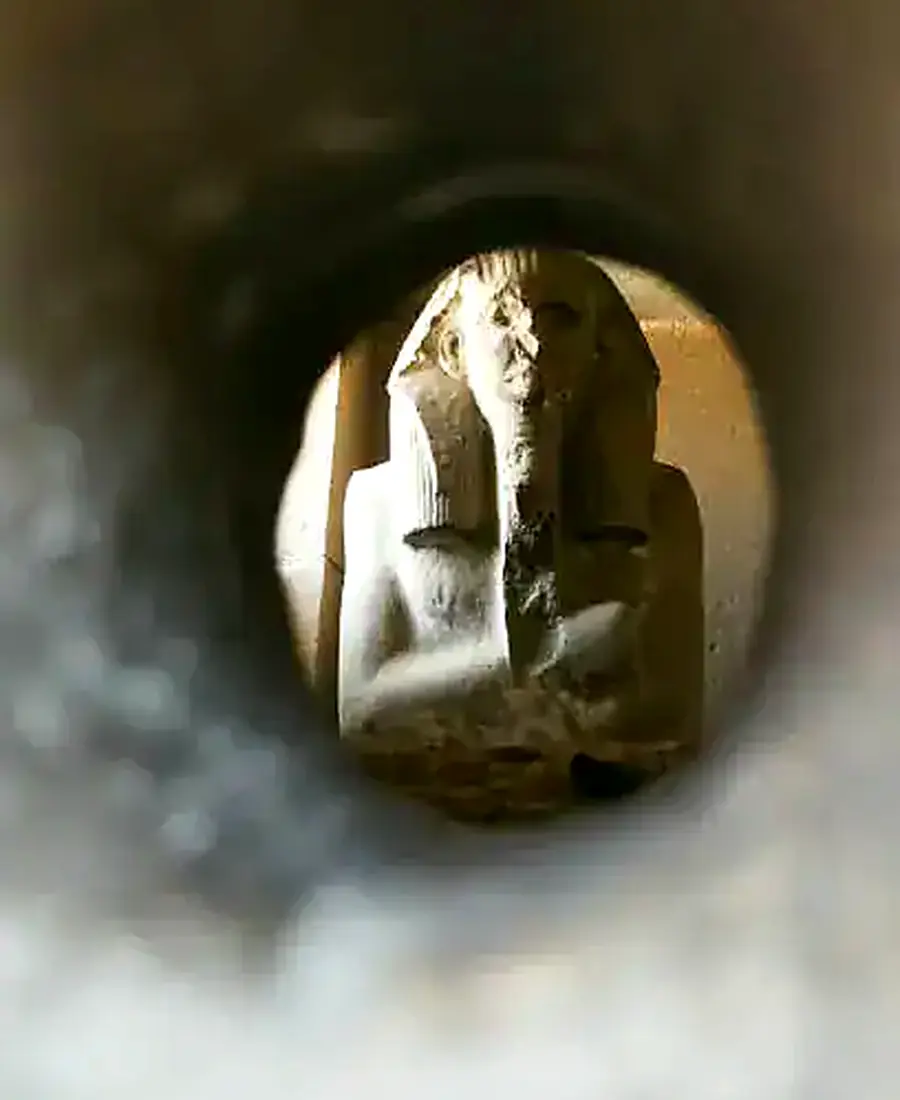 Statue of King Djoser viewed through the serdab opening