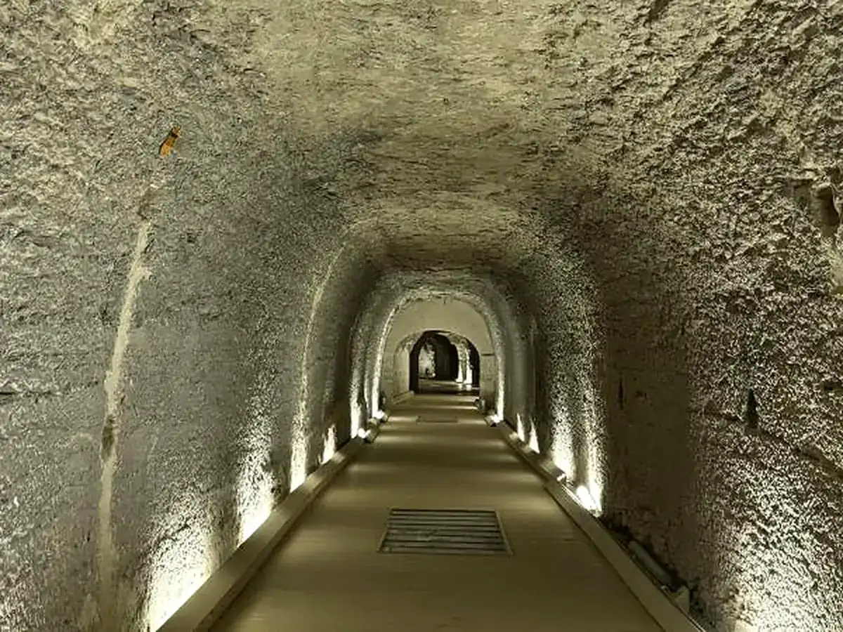 Long illuminated rock-cut gallery beneath Saqqara