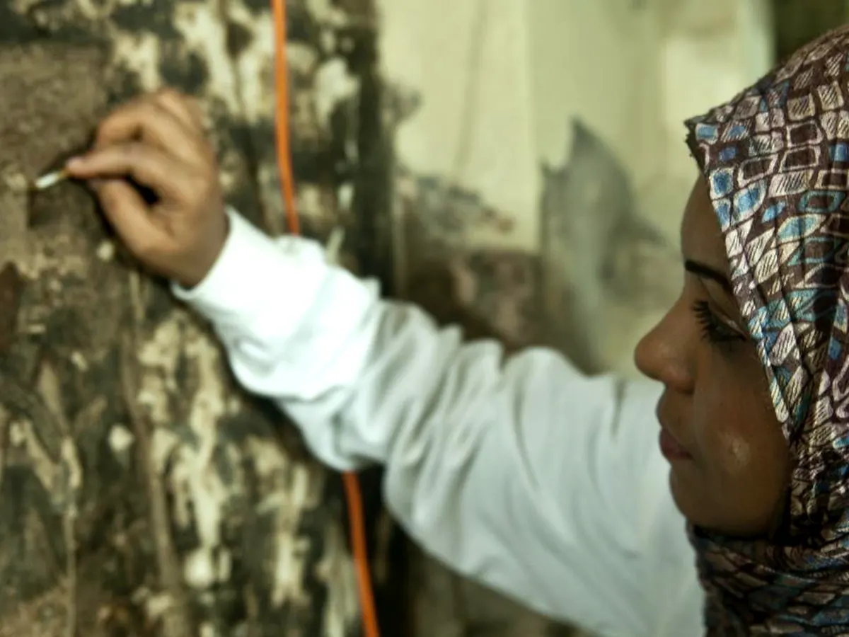 Conservator treating fragile ancient Egyptian painted plaster
